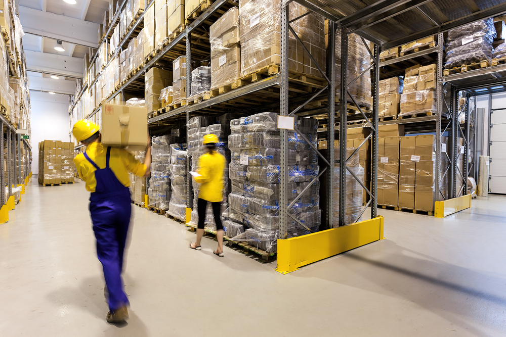 Warehouse worker with box and manager controlling products Warehouse worker with box and manager controlling products